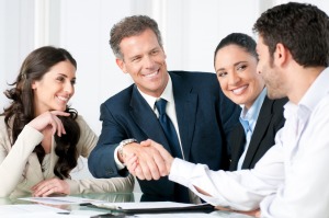 Steps-to-Hiring-a-New-Employeeteam-smiling-with-handshake